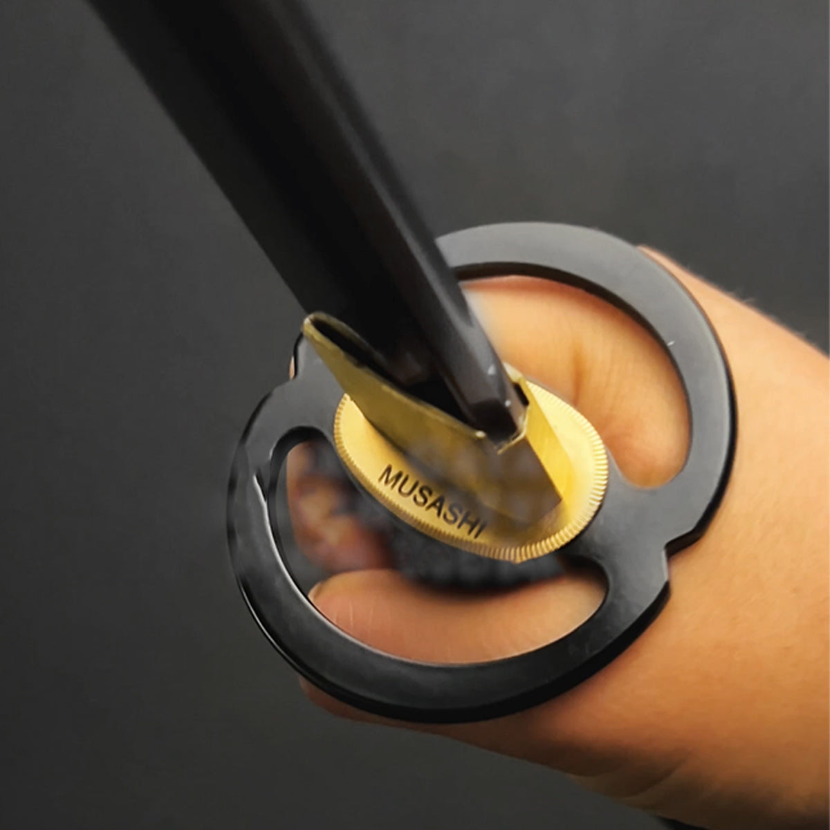 Hand holding Musashi "Infinity Ring" Black Katana.
